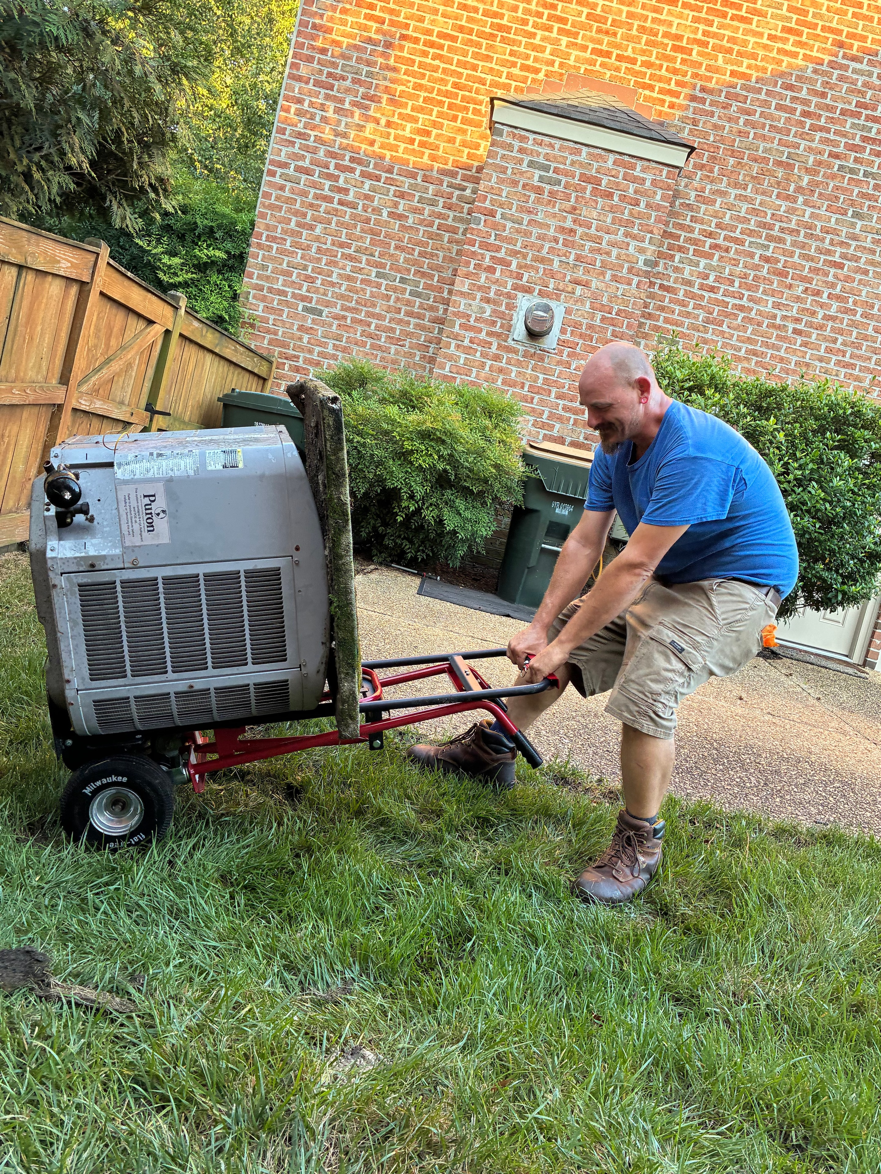 M&J Services technician hauling out old condenser