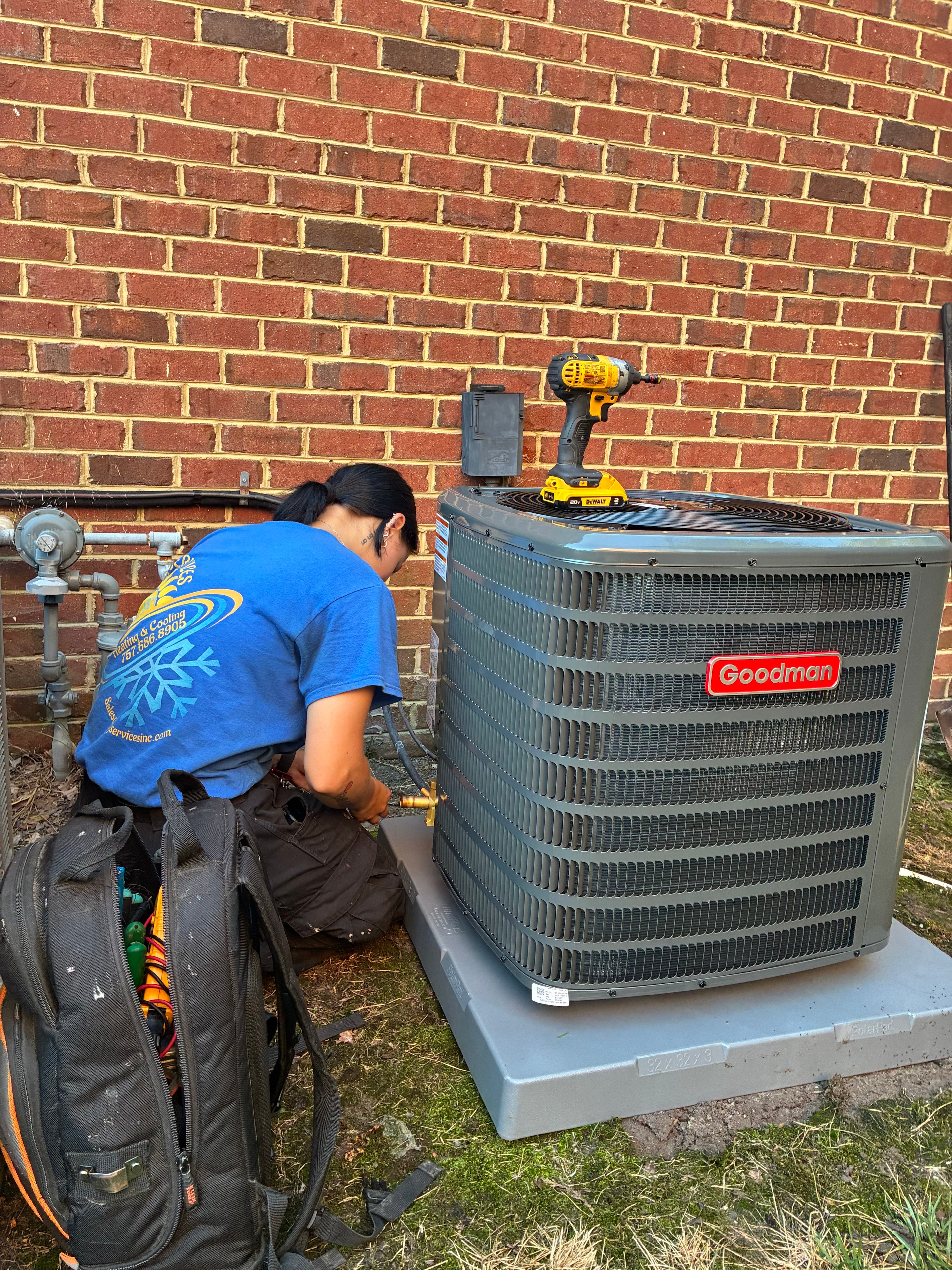 M&J Services technician working on Goodman condenser